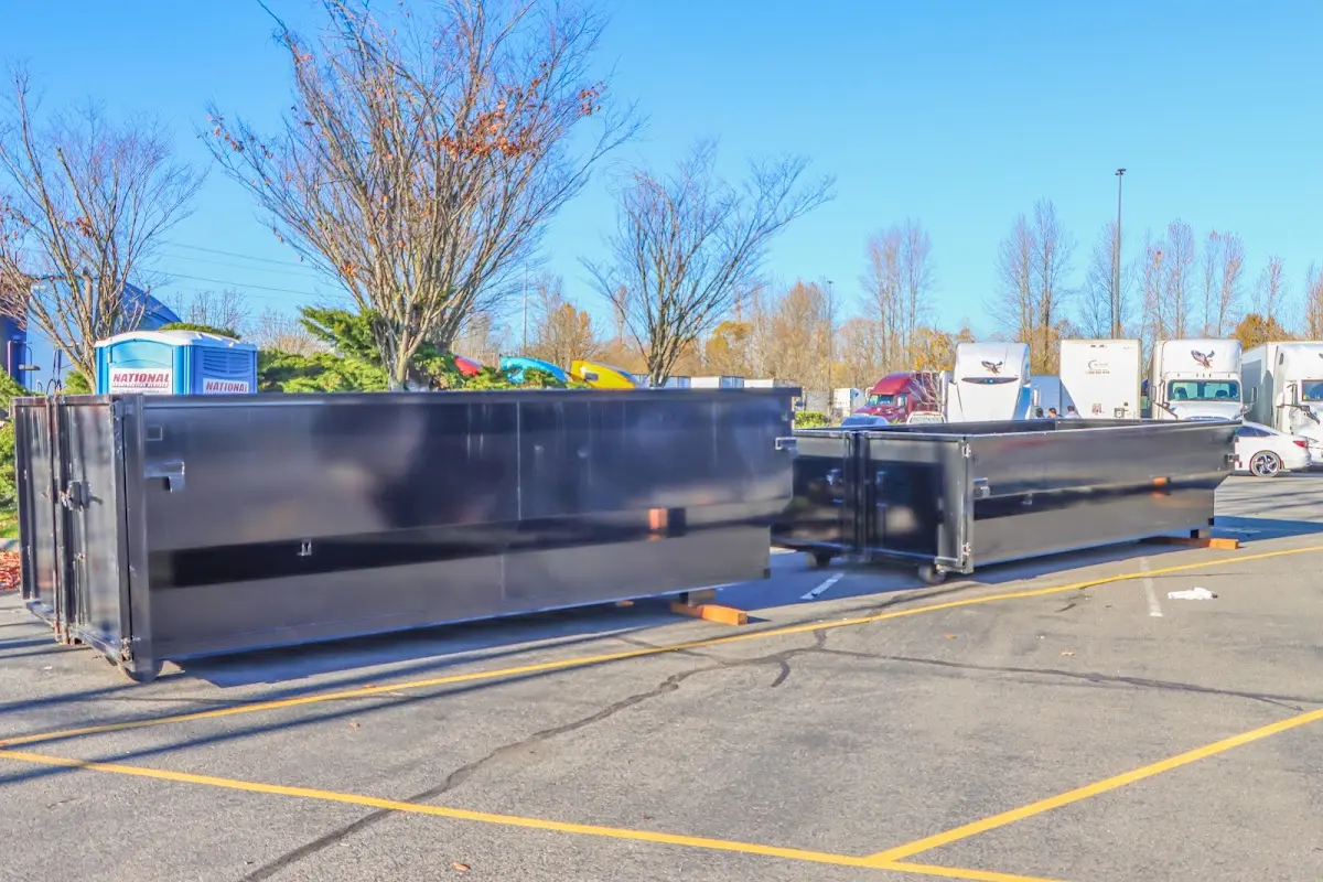 Professional dumpster rental service with roll-off container on residential driveway in Killingly